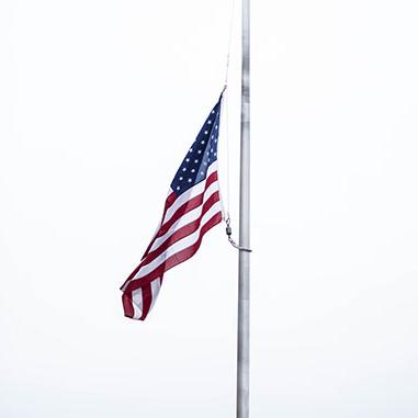 The American flag at half-mast | photo by Eastman Childs