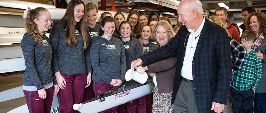 SPU donors Daryl and Claudia Vander Pol christen a racing shell gifted to the women's rowing team.